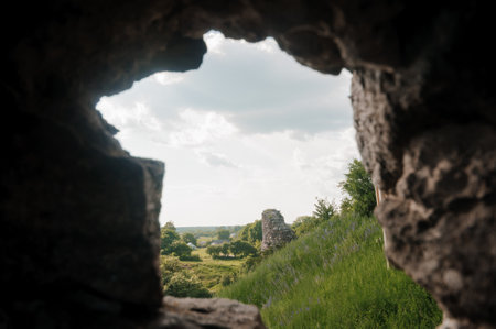 A Serene Glimpse Through Ancient Ruins Framed by Nature's Splendor.の写真素材