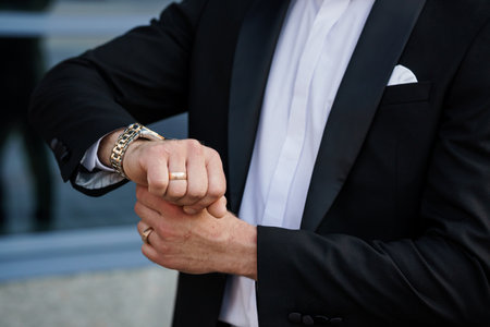 Elegant Groom's Hands Showcasing Stylish Accessories on Wedding Day.の写真素材