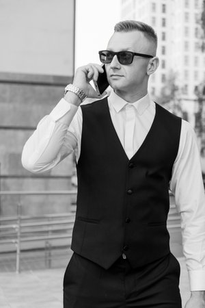 Dapper Businessman in Stylish Attire Engaged in Conversation.