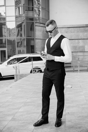 Sophisticated Elegance: A Stylish Man in a Sleek Urban Setting.の写真素材