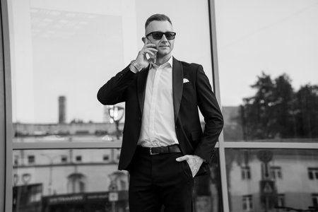 Sophisticated Elegance: A Stylish Man in Formal Attire Captured in Monochrome.の写真素材