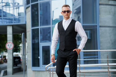 Stylish Man in Elegant Attire Posing Outdoors with Confidence.の写真素材