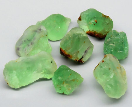 Collection of Raw Green Gemstones Displayed on a Light Background.の写真素材