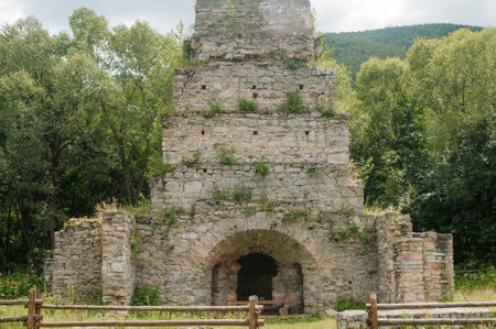 Ancient Stone Ruins Surrounded by Lush Greenery and Mountains.