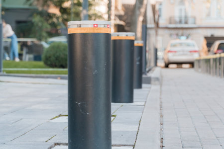 Elegant Urban Barrier Stanchions with Illuminated Safety Markers in a Modern Streetscape.