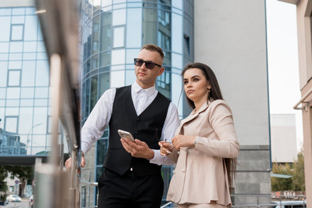 Stylish Business Couple Engaging in Conversation in a Modern Urban Setting.