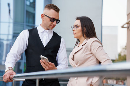 Stylish Business Attire: A Modern Couple Engaged in Conversation.の写真素材