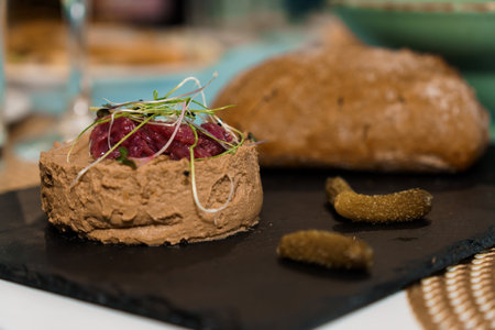 Gourmet Chicken Liver with Microgreens and Accompaniments on a Slate Plate.の写真素材