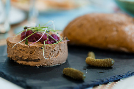 Gourmet Chicken Liver Pate with Microgreens and Homemade Bread on Slate Platter.