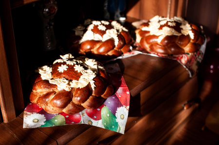 Three Beautifully Decorated Sweet Breads with Floral Buttercream Accents on a Wooden Table.