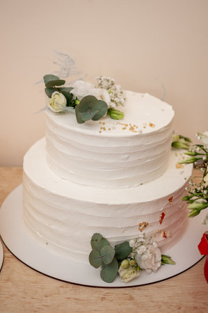 Elegant Two-Tiered White Wedding Cake with Floral Accents.の写真素材