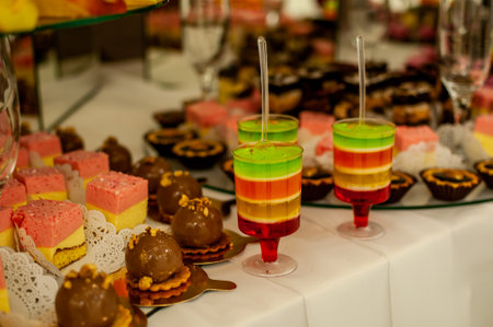 Colorful Dessert Table Featuring Layered Jello and Assorted Treats.の写真素材