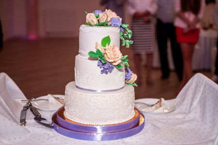 Elegant Three-Tiered Wedding Cake Adorned with Floral Accents.