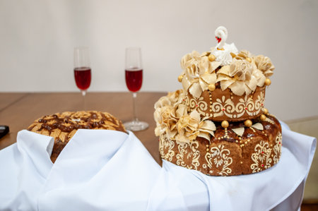 Exquisite Celebration Cakes with Wine Glasses on a Table.の写真素材