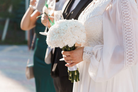 Elegant Bride Holding a White Bouquet at a Wedding Ceremony.
