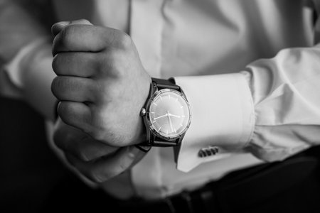 Elegant Wristwatch Display on Dressed Hand.