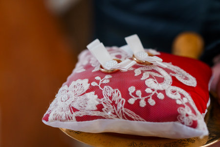 Elegant Red Ring Pillow with Lace Decor.の写真素材
