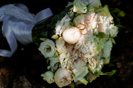 Elegant Wedding Bouquet with Rings and White Roses.の写真素材