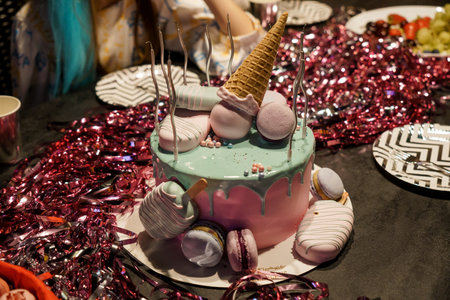 Colorful Celebration Cake with Macarons and Ice Cream Cone Decoration.の写真素材