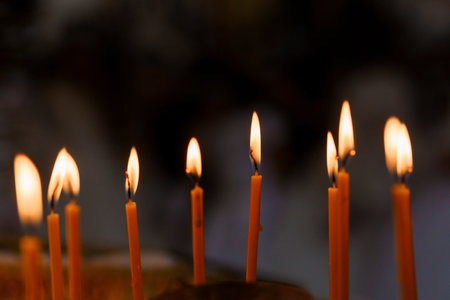 Glowing Candles Illuminating the Darkness in a Serene Setting.の写真素材