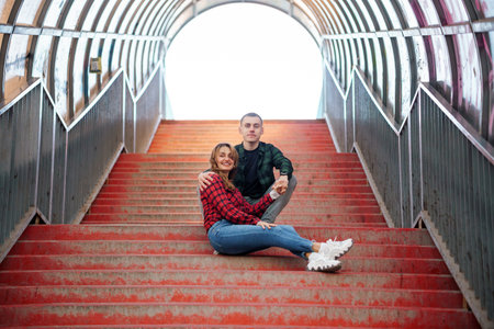 A Joyful Couple Embracing Their Love on a Colorful Staircase.の写真素材