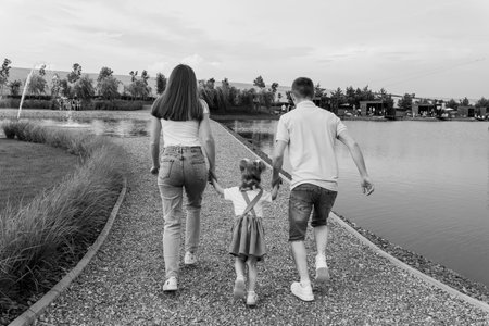 Family Stroll by the Tranquil Lake at Sunset.