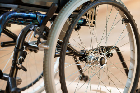 Close-Up of a Wheelchair Wheel Focusing on Spokes and Frame Details.の写真素材