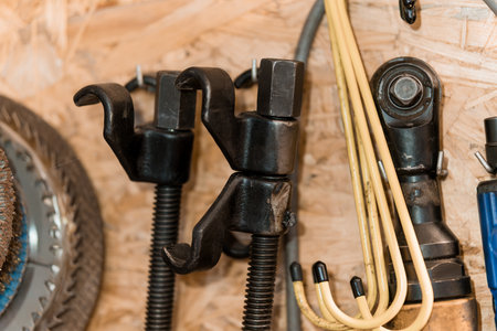 Detailed Close-Up of Various Mechanical Tools Hang on a Wooden Wall.の写真素材