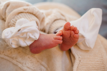 Sweet Baby Feet in Cozy Knitted Outfit.の写真素材