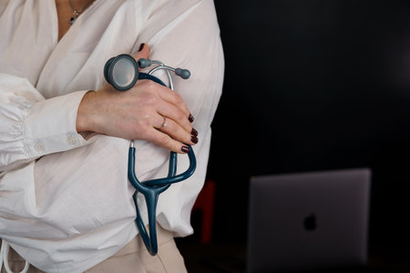 Professional Woman Holding a Stethoscope in a Modern Office Setting.