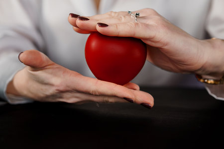 A Gentle Embrace of a Red Heart Symbolizing Care and Compassion.