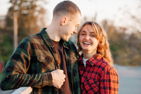 Joyful Couple Embracing at Sunset in Flannel Shirts.