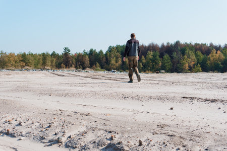 A Solitary Walker in a Landscape Surrounded by Autumn Foliage.の写真素材