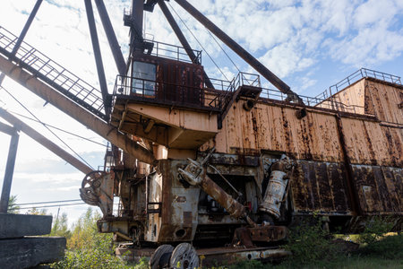 Abandoned Industrial Machinery in a Verdant Landscape.の写真素材