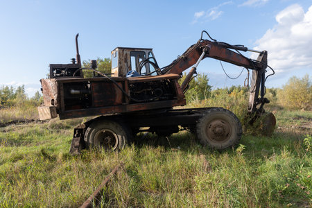 Abandoned Excavator in Overgrown Landscape.の写真素材