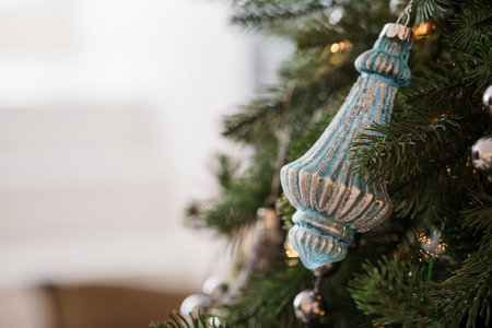 Elegant Vintage Blue Christmas Ornament Hanging on a Festive Pine Tree.の写真素材