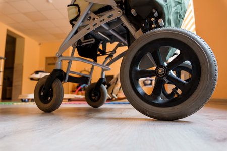 Close-Up of a Stroller Wheel on a Wooden Floor.
