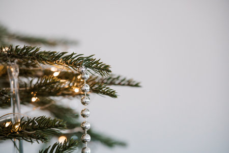 Christmas Tree Decorated with Silver Beads and Warm Lights.