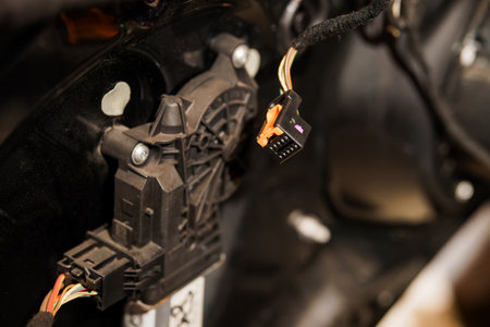 Close-up of Electrical Connector and Component in Vehicle Interior.