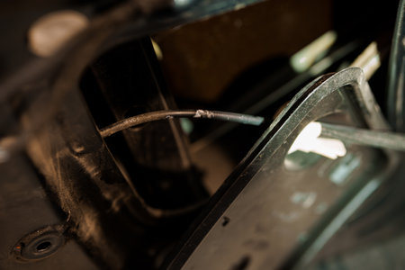 Intricate Close-Up of Car Component with Wiring and Mechanical Details.