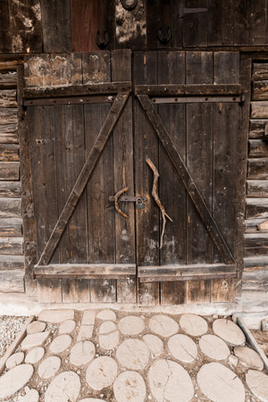 Rustic Wooden Barn Doors with Cobblestone Pathway.の写真素材