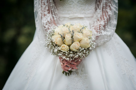 Elegant Wedding Bouquet of White Roses with Delicate Lace Dress.の写真素材