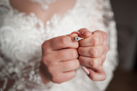 Elegant Bride Holding Engagement Ring in Delicate Hands.の写真素材