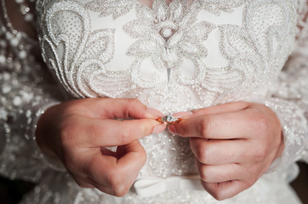 A Bride's Elegance: Close-Up of Wedding Dress Embellishments and Ring.の写真素材