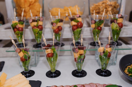 Colorful Salad Cups Garnished with Fresh Vegetables and Fruits at a Buffet.の写真素材