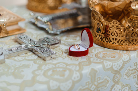 A Beautifully Arranged Wedding Scene with Rings and Religious Artifacts.の写真素材