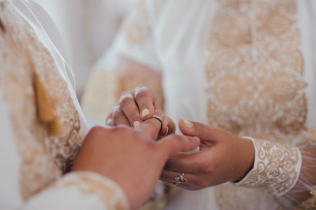 Elegant Wedding Ring Exchange Ceremony Captured in Soft Natural Light.の写真素材
