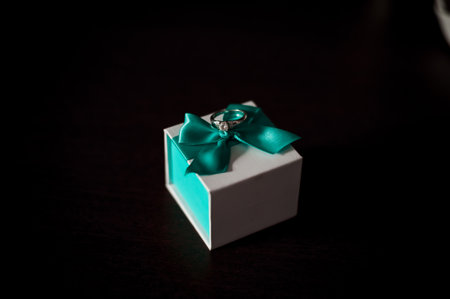 Elegant Jewelry Gift Box with Turquoise Ribbon and Engagement Ring.の写真素材