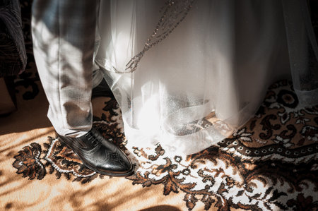 Elegant Wedding Attire with Detailed Footwear and Romantic Textiles.の写真素材