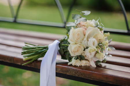 Delicate Bridal Bouquet on a Rustic Bench.の写真素材